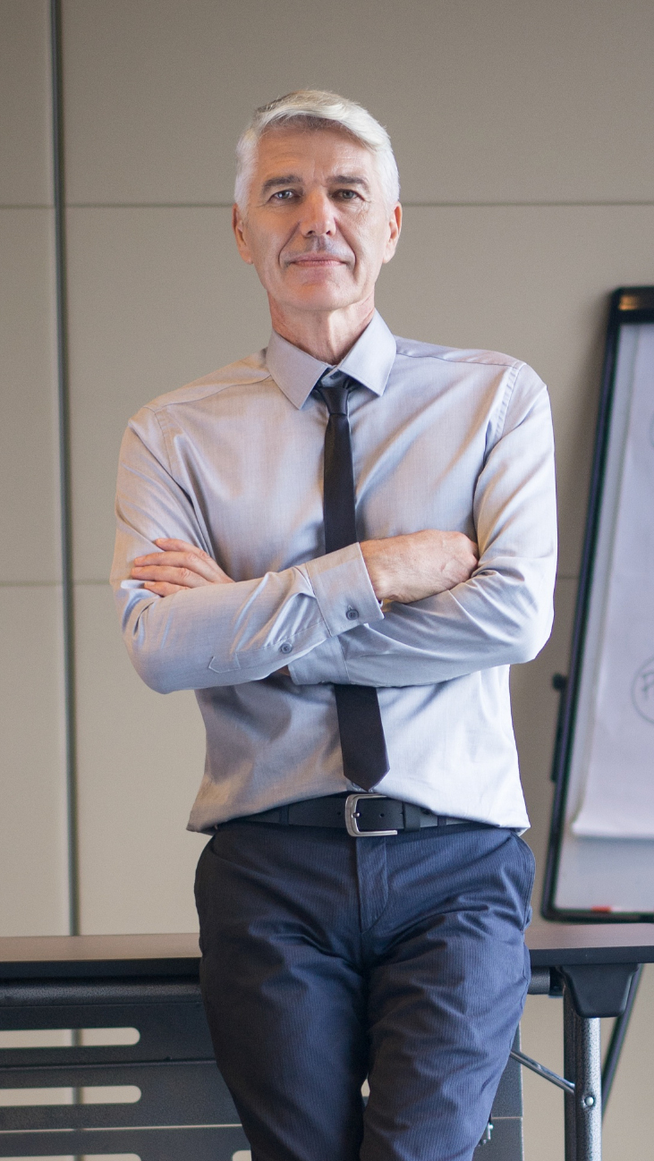senior-lecturer-with-arms-crossed-flipchart